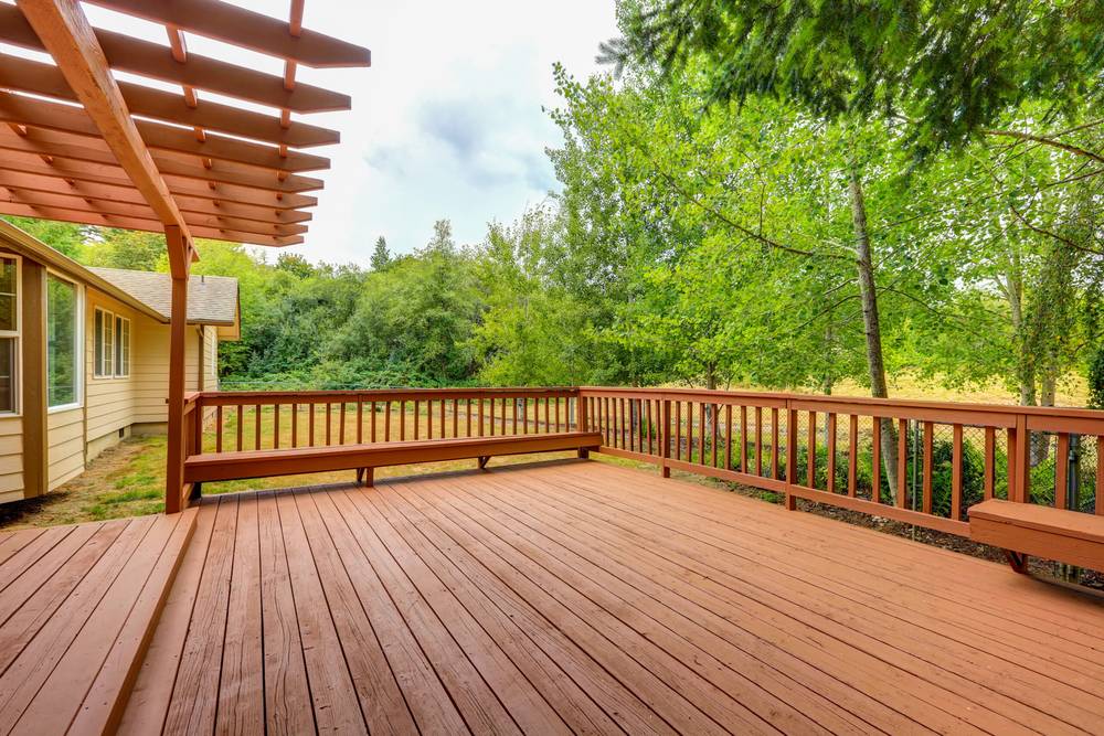 Craftsman measuring and fitting deck boards with precision