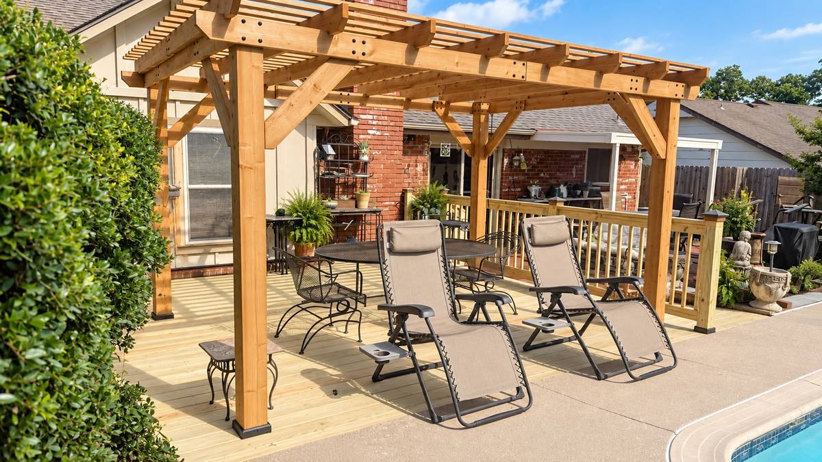 Cedar pergola over a poolside patio with lounge chairs