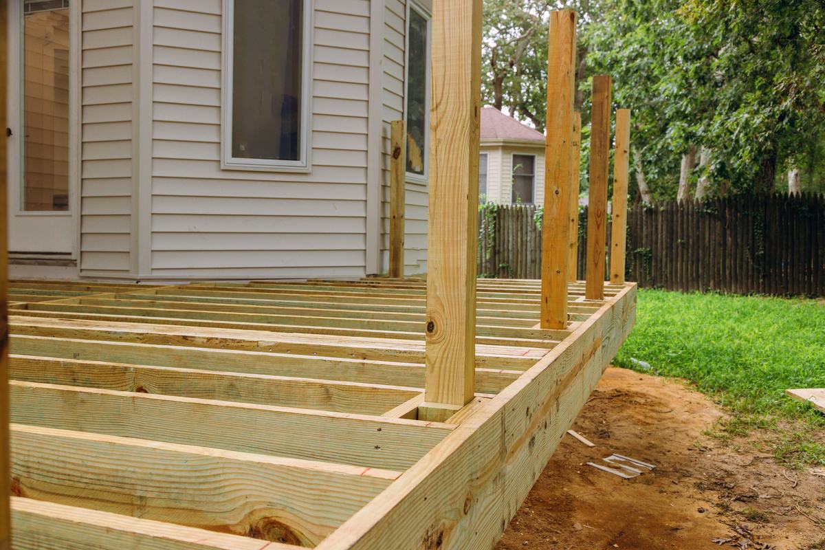 Pressure-treated deck framing with joists and posts set before decking