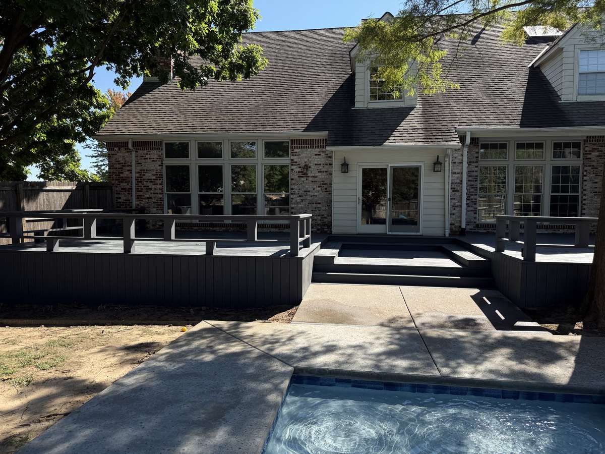 Dark composite deck with pool and multi-level seating areas