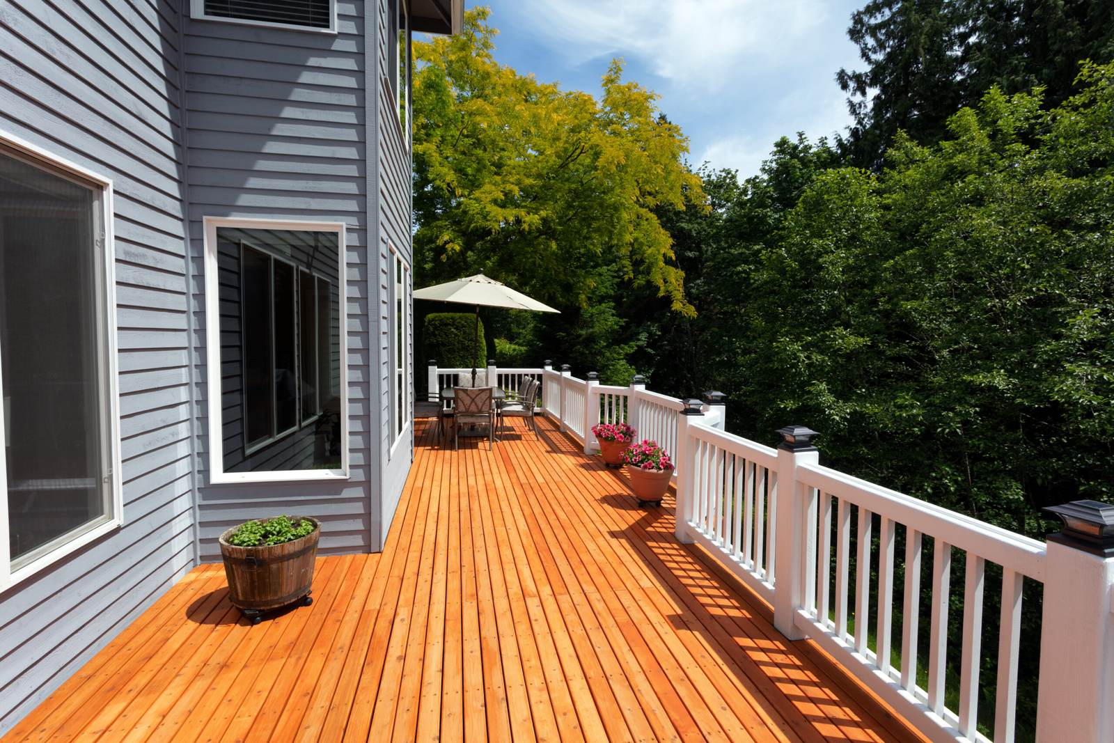 Stained wood deck with white railing on a Nashville home